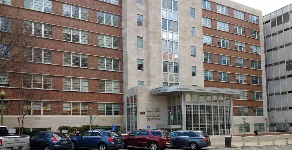 Exterior street-level view of the University of Alabama at Birmingham (UAB) School of Dentistry building, with its entrance signage visible, in Birmingham, Alabama, USA.
