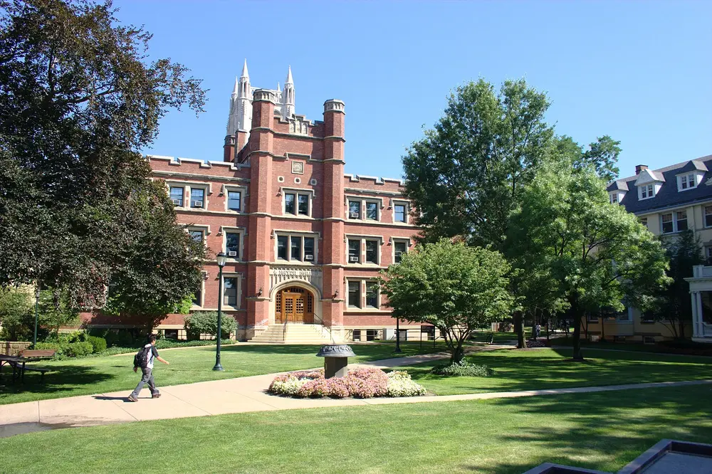 Collegiate-Gothic building (Haydn Hall) on the Case Western Reserve University campus quad in Cleveland, OH, under a clear blue sky — the host university of the School of Dental Medicine.