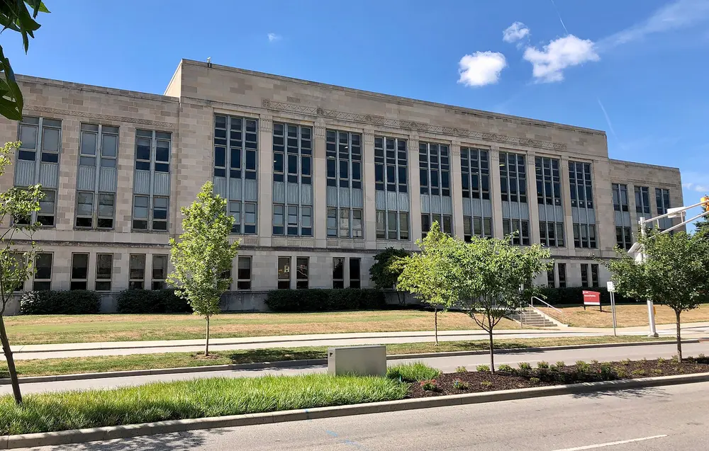 Exterior of the Indiana University School of Dentistry building (the recognizable Art Deco limestone facade) in Indianapolis, Indiana, on a clear day.