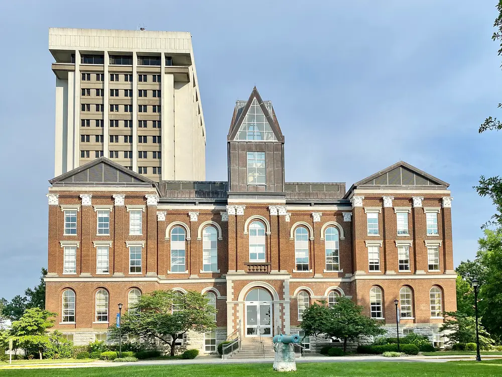Exterior of the University of Kentucky Main Building (Old Main / Administration Building) in Lexington, KY — the iconic red-brick landmark of the host university of the College of Dentistry.