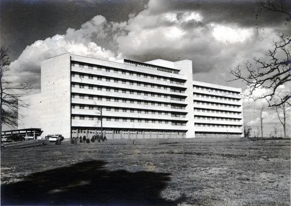 Exterior view of the multistory main hospital building and grounds of the University of Mississippi Medical Center (UMMC) health sciences campus in Jackson, MS — the academic medical center that hosts the School of Dentistry.