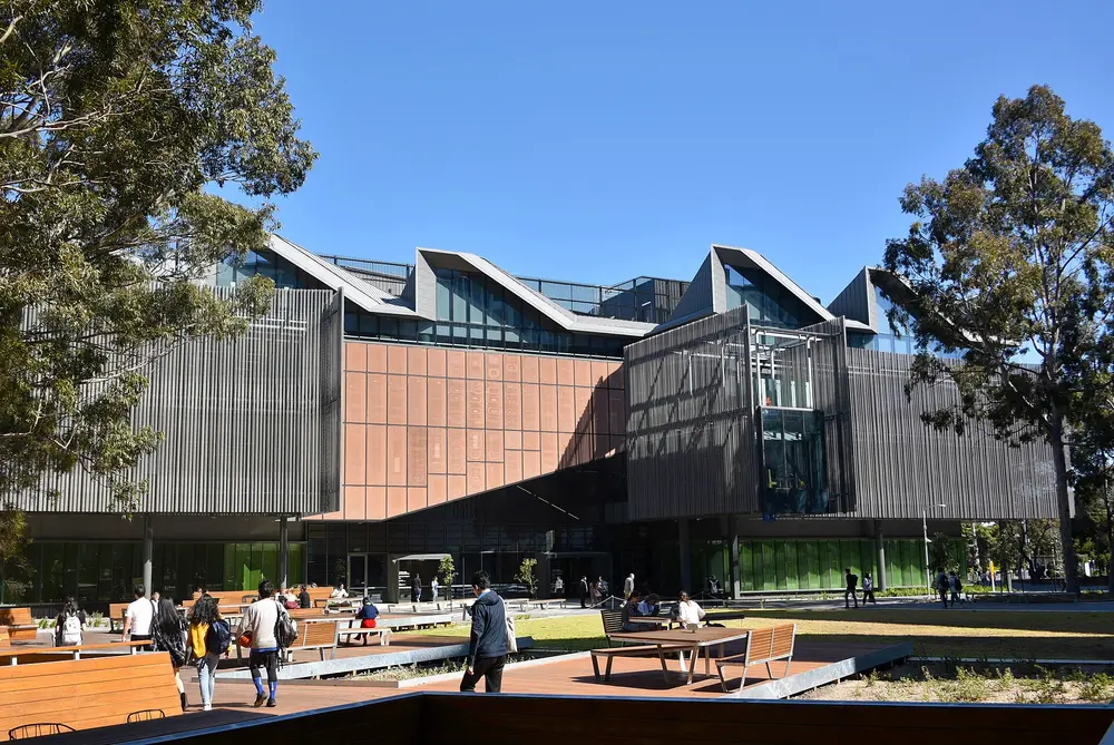 Exterior of the Learning and Teaching Building at Monash University's Clayton campus in Melbourne, Australia, on a clear day with blue sky.