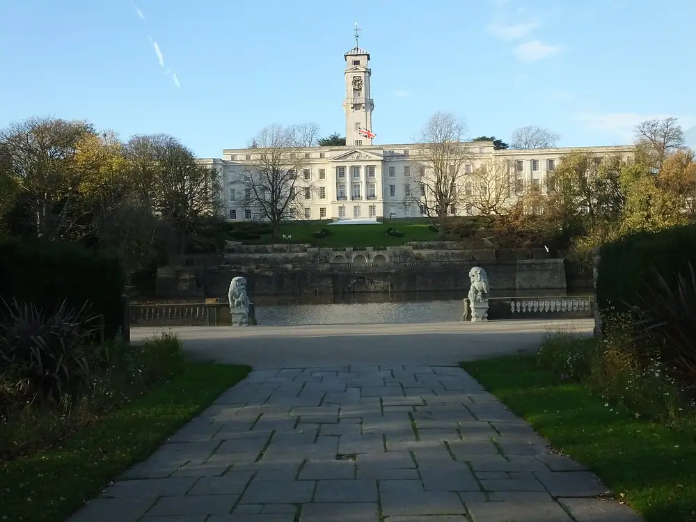 Trent Building clock tower, University Park campus, University of Nottingham, viewed across Highfields boating lake with formal gardens