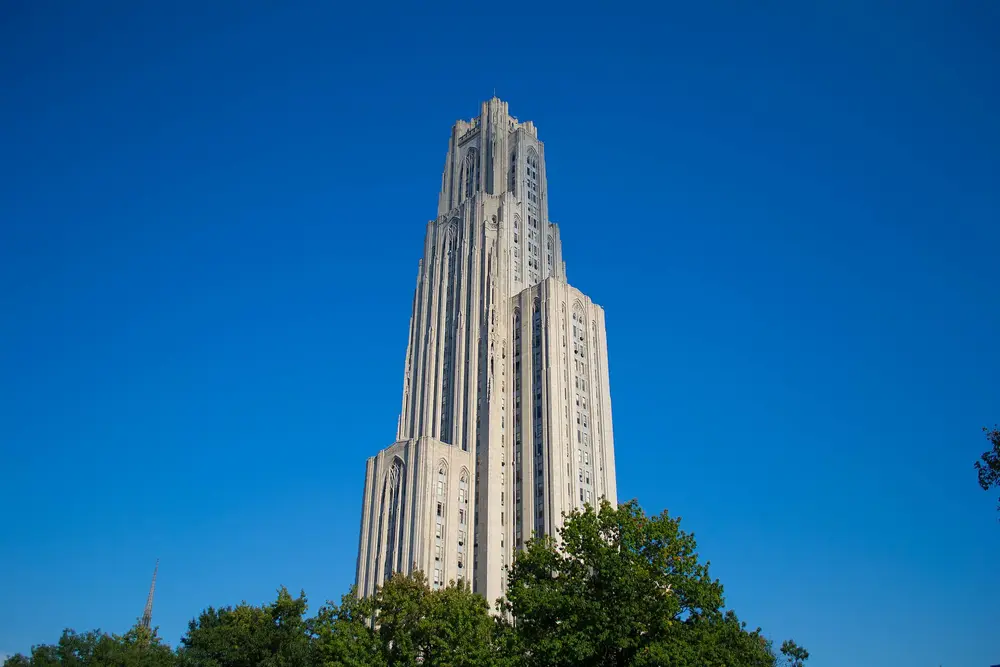 The Cathedral of Learning, the iconic 42-story Gothic Revival tower at the heart of the University of Pittsburgh campus in Pittsburgh, PA — the institution that houses the School of Dental Medicine.