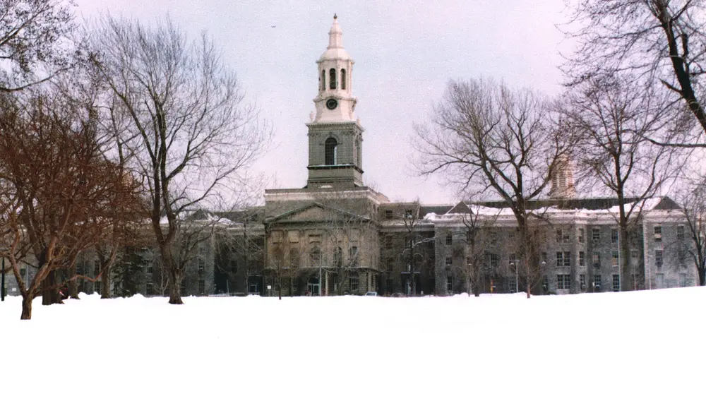 Hayes Hall, the iconic historic clock-tower landmark of the University at Buffalo South Campus (Buffalo, NY) — the campus that hosts the UB School of Dental Medicine.