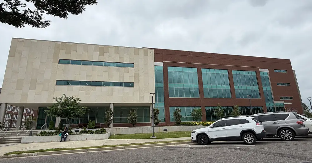 Exterior of the Dunn Dental Building, home of the University of Tennessee Health Science Center College of Dentistry, Memphis, TN — modern limestone-and-brick facade with a "University of Tennessee" sign.